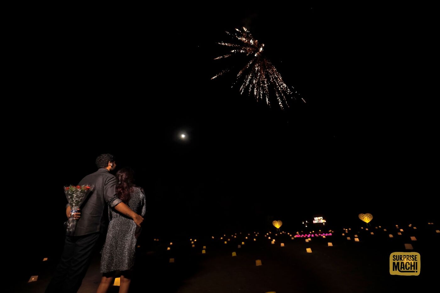 Anniversary surprise on the beach with fireworks at night