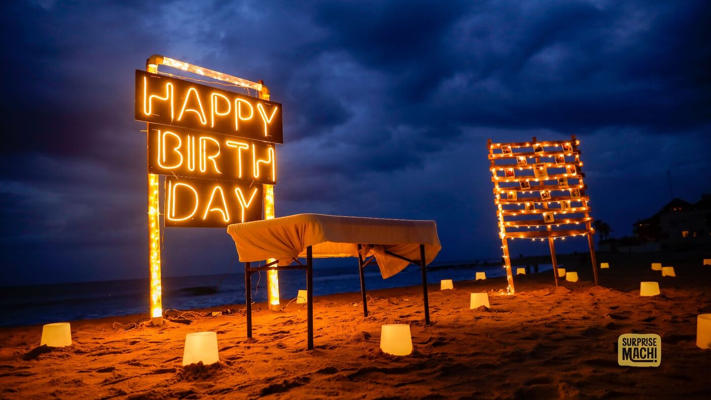 Birthday beach surprise setup with Happy Birthday neon sign