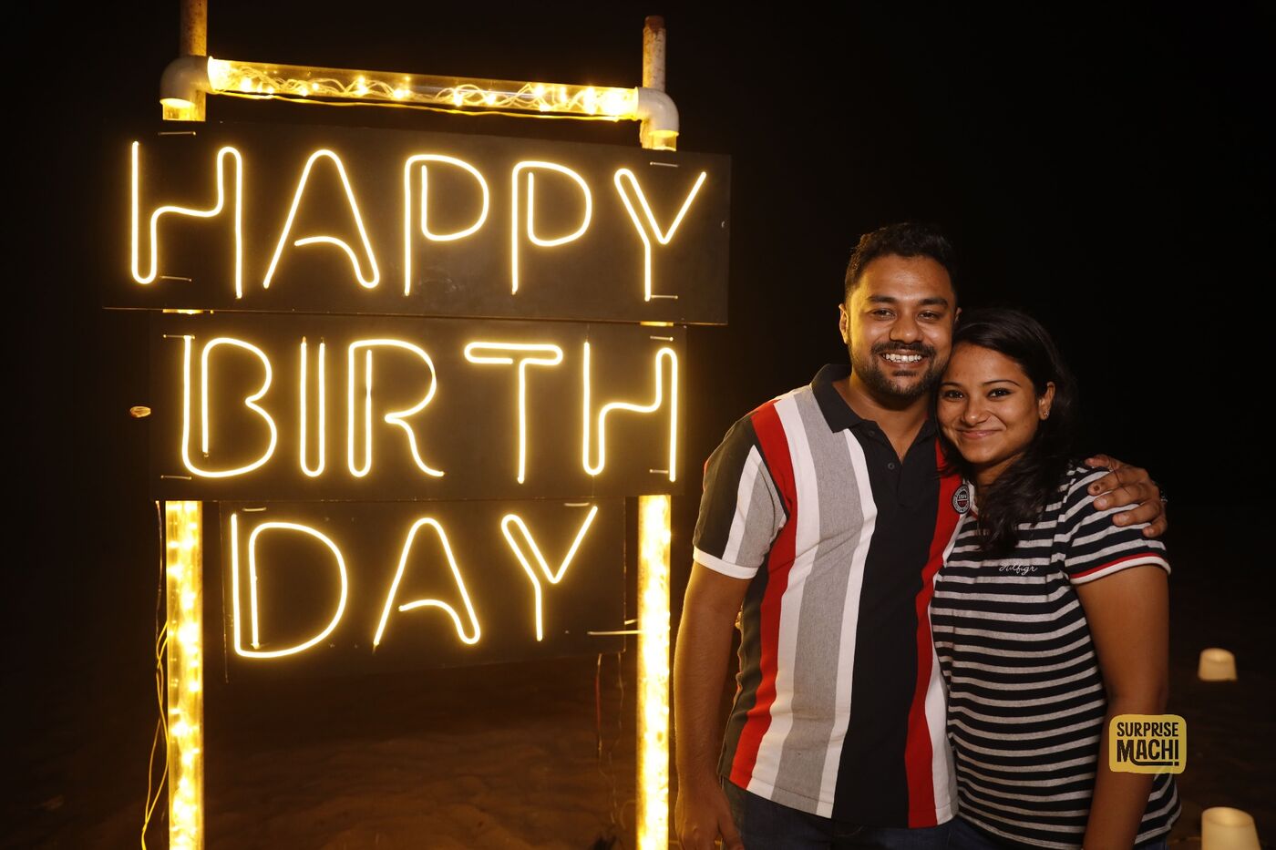 Couple at Happy Birthday beach surprise